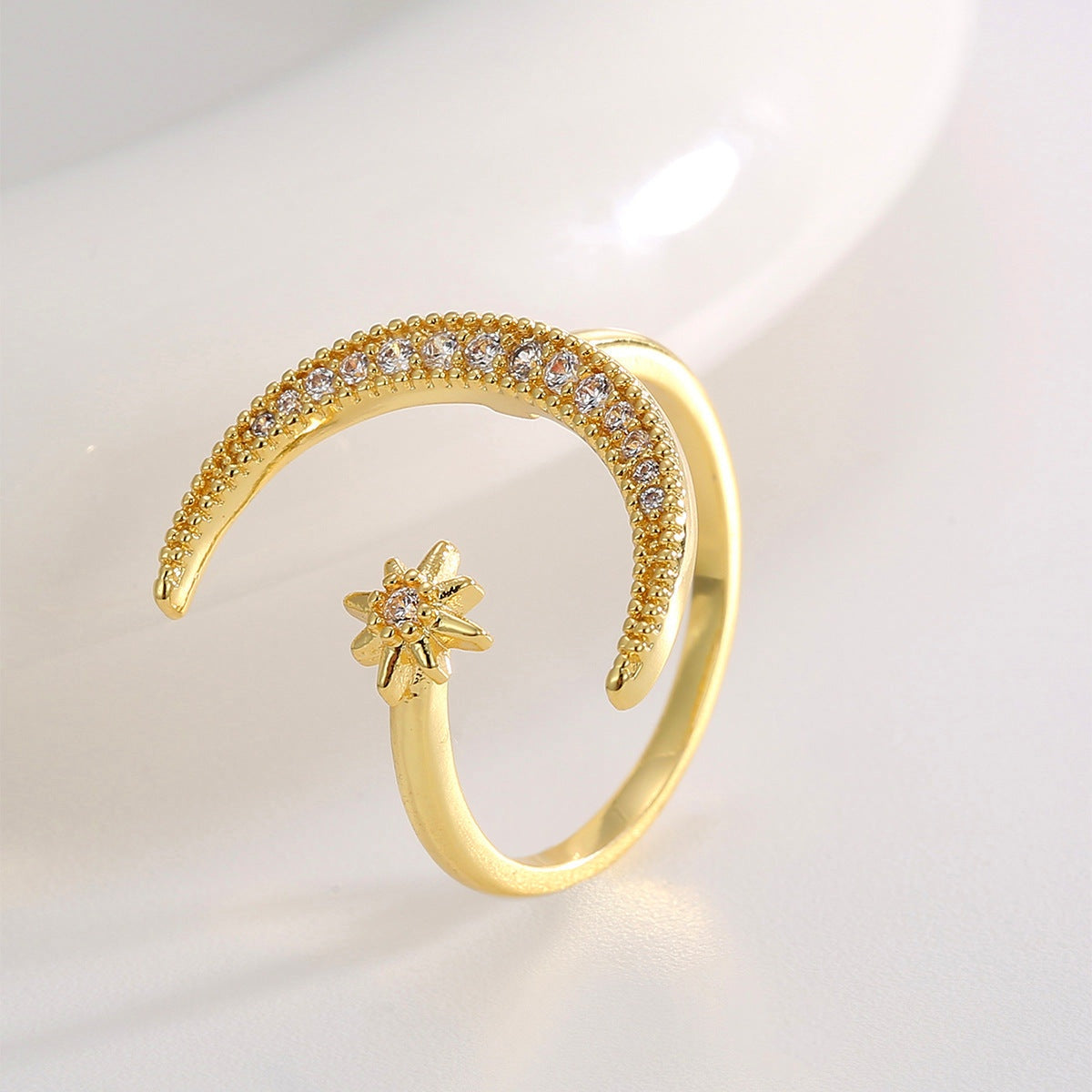 Crescent diamond-encrusted open tail ring